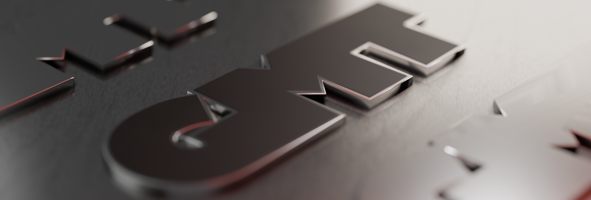 Nahaufnahme des GMT Logos auf einer Metalloberfläche.